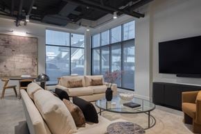 Los Angeles apartment for rent - A living room with a large window, a couch, a coffee table, and a television at Skylar At Sunset Apartments, Los Angeles