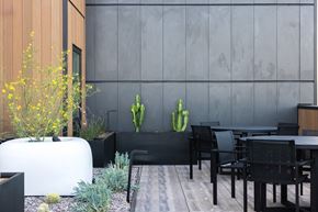 Los Angeles apartment for rent - A modern outdoor dining area with a wooden table and chairs at Skylar At Sunset Apartments, Los Angeles, CA