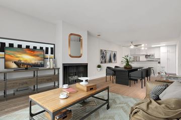Los Angeles apartment for rent - A modern living room with a fireplace and a painting on the wall.