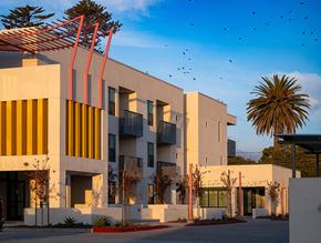 Chula Vista apartment for rent - A modern building with a white facade and yellow accents.