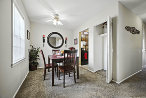 Indianapolis apartment for rent - Dining area in a 2-bedroom Ashton Pointe apartment with a carpeted floor and natural light from windows.