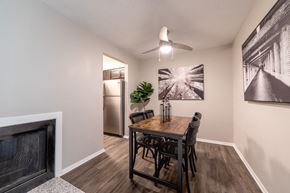 Bloomington apartment for rent - Dining area with ceiling fan and artwork at Woodbridge of Bloomington Apartments, Indiana, 47408