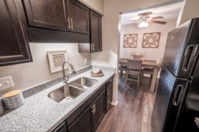 Indianapolis apartment for rent - Renovated Kitchen with granite countertops and stainless-steel sink at Chelsea Village Apartments
