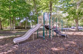 Indianapolis apartment for rent - Playground equipment and slide at The Woods of Eagle Creek