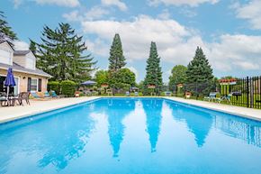 Mishawaka apartment for rent - Swimming pool with seating at University Park Apartments