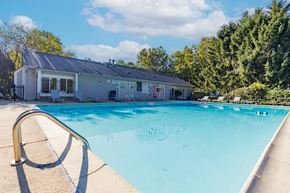 Bloomington apartment for rent - Outdoor swimming pool with poolhouse and lounge chairs at Woodbridge of Bloomington Apartments, Bloomington, 47408