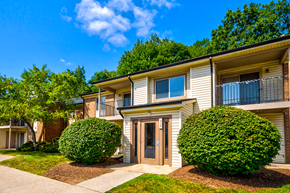 Michigan City apartment for rent - Exterior view of an apartment building at Woodland Crossing, featuring balconies and patios on upper and lower levels.