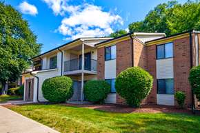 Michigan City apartment for rent - Exterior view of an apartment building at Woodland Crossing, featuring balconies and patios on upper and lower levels.