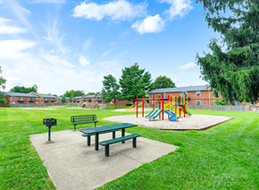 Louisville apartment for rent - Apartment playground and picnic area at Mount Vernon, featuring play equipment, benches, and open space for outdoor activities.