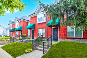 Louisville apartment for rent - Exterior view of the building at Hampton Place Apartments, showcasing architecture and well-maintained landscaping.