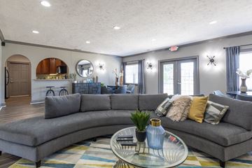 Greenwood apartment for rent - a living room with a gray couch and a glass coffee table