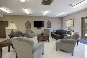 Bowling Green apartment for rent - A living room with a grey couch and a television.