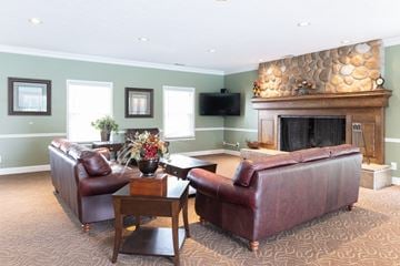 Mishawaka apartment for rent - a living room with two leather couches and a fireplace