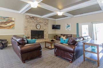 Indianapolis apartment for rent - a living room with leather furniture and a fireplace