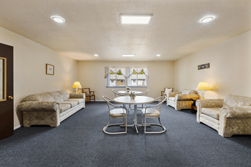 Shelbyville apartment for rent - A living room with a round table and chairs in the center.