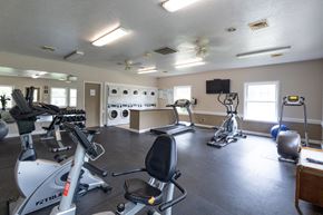 Mishawaka apartment for rent - a gym with treadmills and other exercise equipment and a tv