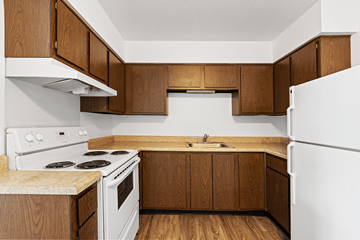 Lebanon apartment for rent - A kitchen with white appliances and wooden cabinets.