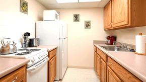 Williamsville apartment for rent - Kitchen in a one-bedroom apartment at Village Square Apartments with appliances, ample counter space, and storage cabinets.