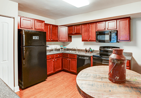 Indianapolis apartment for rent - Kitchen in a Signature series 2-bed, 2-bath apartment at Somerset Lakes, featuring appliances and cabinets.