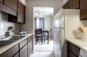 Mishawaka apartment for rent - an open kitchen and dining room with a table and a refrigerator