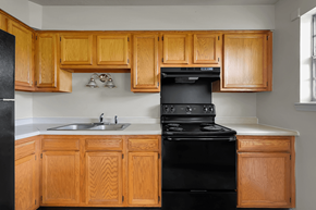 New Albany apartment for rent - Kitchen in a 3-bed, 1-bath townhome at Valley Ridge Apartments with kitchen appliances and ample cabinetry.