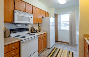 Lafayette apartment for rent - Kitchen with a stove, microwave, and refrigerator  at Copper Gate, Lafayette, 47909