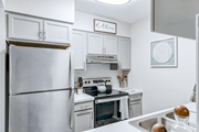 Lorton apartment for rent - Kitchen in a 2-bedroom, 1-bath apartment at Woods of Fairfax, with an electric stove and stainless steel appliances at The Woods of Fairfax Apartments, Lorton, Virginia