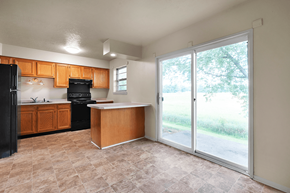 New Albany apartment for rent - Kitchen with an island in a 3-bed, 1-bath townhome at Valley Ridge Apartments, featuring kitchen appliances and ample counter space.