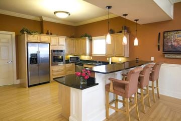 Noblesville apartment for rent - A kitchen with a bar area and chairs.