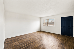 Bloomington apartment for rent - Living room in a 2-bedroom, 1-bathroom townhome at Country View Apartments, featuring hardwood floors, and windows.