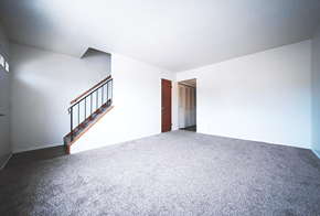 Bedford apartment for rent - Living room in a 2-bedroom townhome at Rainbow Hills Apartments with spacious layout and natural light.