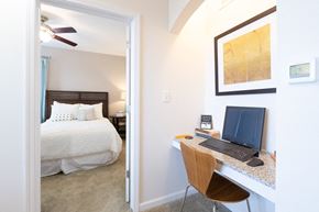 Zionsville apartment for rent - A bedroom with a bed, desk, and chair.