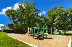 Columbus apartment for rent - Playground at Briarwood Apartments, Columbus, IN, with swings, slides, and green space.