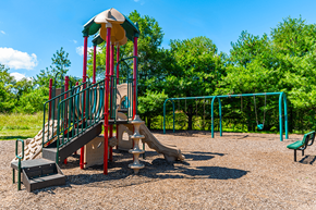 Elkhart apartment for rent - Playground at North Lake Apartments with slides and swings.