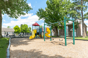 Indianapolis apartment for rent - Playground with slides and swings at Northwood on the Trail.