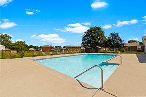 Indianapolis apartment for rent - Swimming pool at Windsor Park Apartments, surrounded by lounge chairs offering a relaxing outdoor space.
