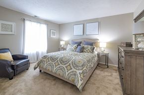 Mishawaka apartment for rent - a bedroom with a bed and a dresser and a window
