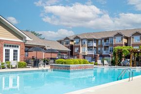 Zionsville apartment for rent - A swimming pool in front of apartment buildings.
