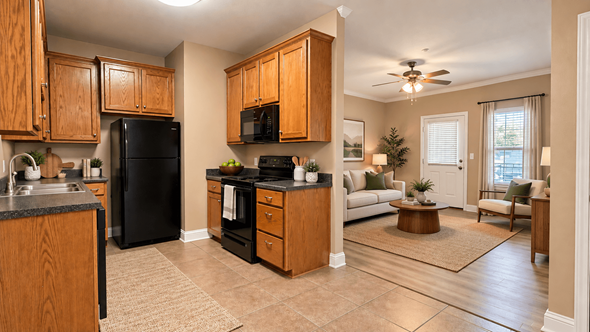 Sulphur Springs apartment for rent - A kitchen with a black refrigerator and wooden cabinets.