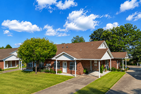 Lindale triplex for rent - A house with a red brick exterior and a white roof.
