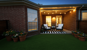 Greenville apartment for rent - A cozy outdoor space with a brick wall and a striped rug.