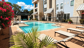 Little Elm apartment for rent - A pool surrounded by lounge chairs and a fence.