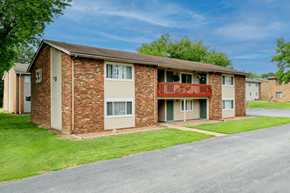 Shiloh apartment for rent - A brick apartment building with a red balcony.