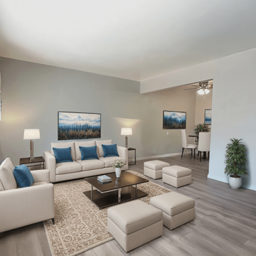 Shiloh apartment for rent - A living room with a white couch, a coffee table, and a painting on the wall.