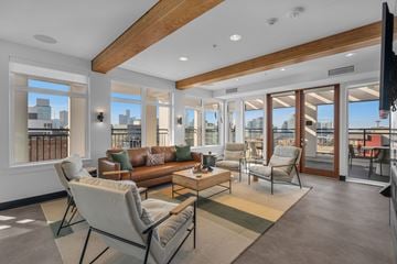 Seattle apartment for rent - A living room with a brown couch and a white chair.