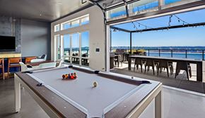 Tacoma apartment for rent - a games room with a pool table and a view of the water