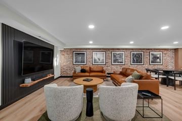 Seattle apartment for rent - A modern living room with a brick wall and a wooden floor.
