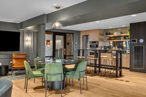 Seattle apartment for rent - A modern dining room with a wooden table and green chairs.