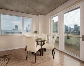 Seattle apartment for rent - a dining room with a table and chairs and sliding glass doors
