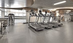 Seattle apartment for rent - a gym with a row of exercise equipment in it